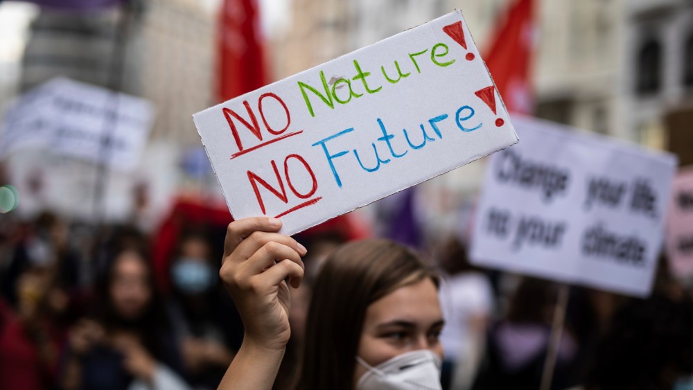 A woman with a sign that reads: 'No nature, no future', participates in a demonstration for the 'Global strike for the climate', in the Plaza de Callao, on September 24, 2021, in Madrid (Spain). The protest movement driven by Fridays for Future-Youth for Climate calls for this Friday a new Global Day of Action for Climate. This time, the day is dedicated to demand justice in the face of the climate emergency and show support to the so-called Climate Trial, which already has more than 48,000 signatures; the complaint filed before the Supreme Court by several organizations against the Government for its lack of commitment and ambition on the issue. According to the promoters, rallies have been called in 16 different locations to demand "ambitious", "immediate" and "concrete" measures for the climate crisis. SEPTEMBER 24;2021;MADRID;CLIMATE EMERGENCY;CLIMATE CHANGE;CLIMATE;GLOBAL ACTION;CLIMATE CRISIS Alejandro Martínez Vélez / Europa Press 09/24/2021 (Europa Press via AP)